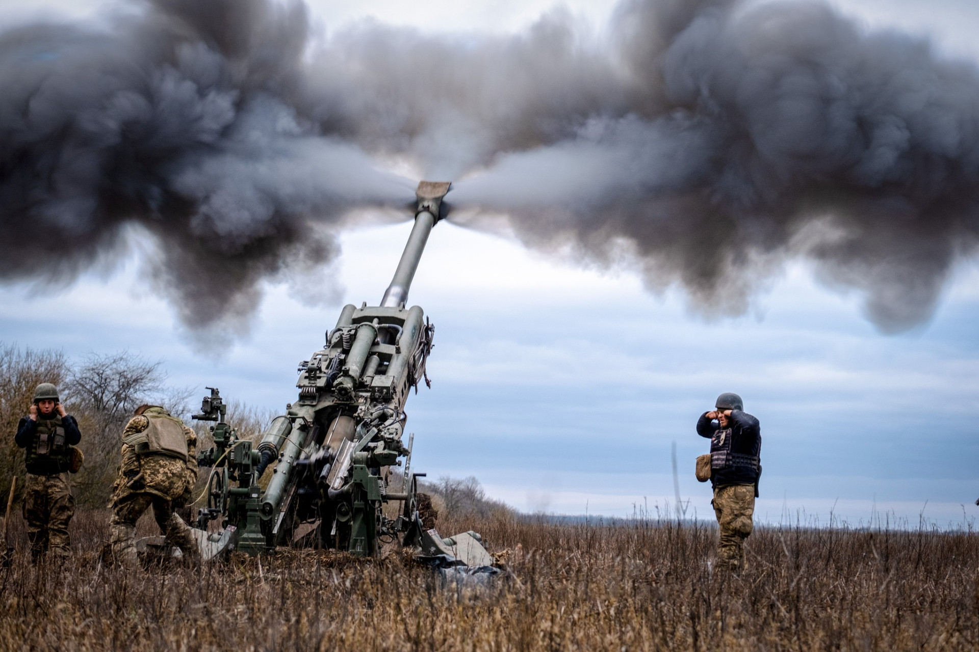 Artillerymen of the 406th Artillery Brigade fire an M777 howitzer