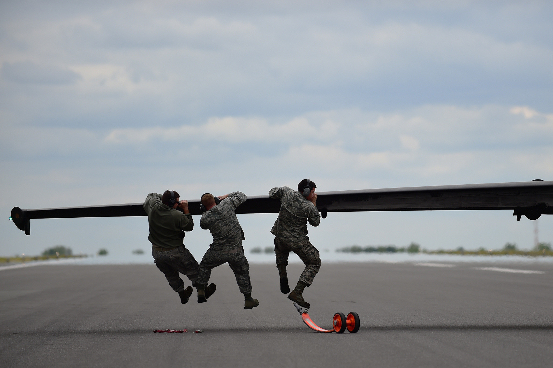 Наземна команда намагається збалансувати Lockheed U-2 після приземлення та встановити додаткове шасі, авіабаза Фейрфорд, Велика Британія, 2015 рік